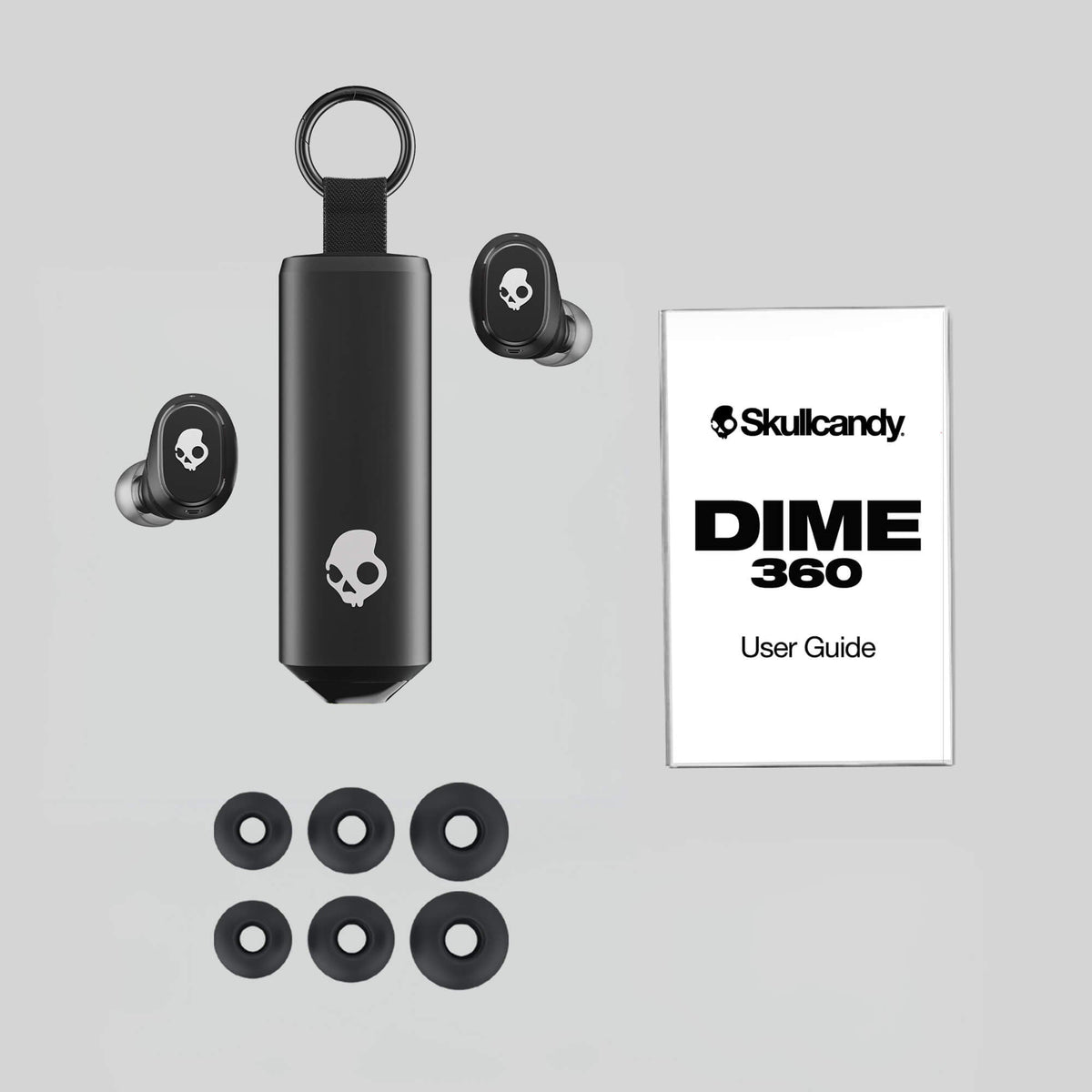Skullcandy Dime 360 earbuds with case and user guide on a gray background  | Skullcandy X Peanuts Spike